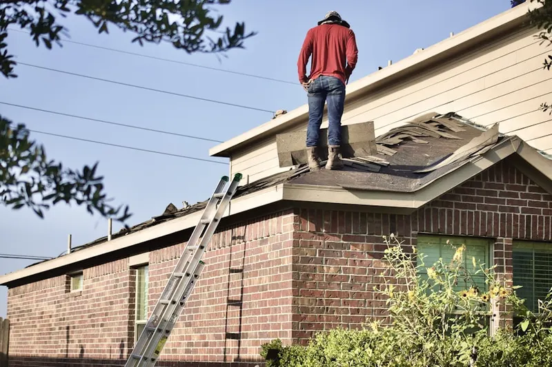 Professional roofer working on a residential roof in New Harrison